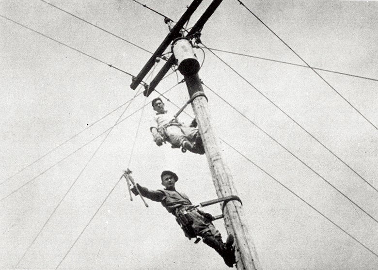 Men on electric pole